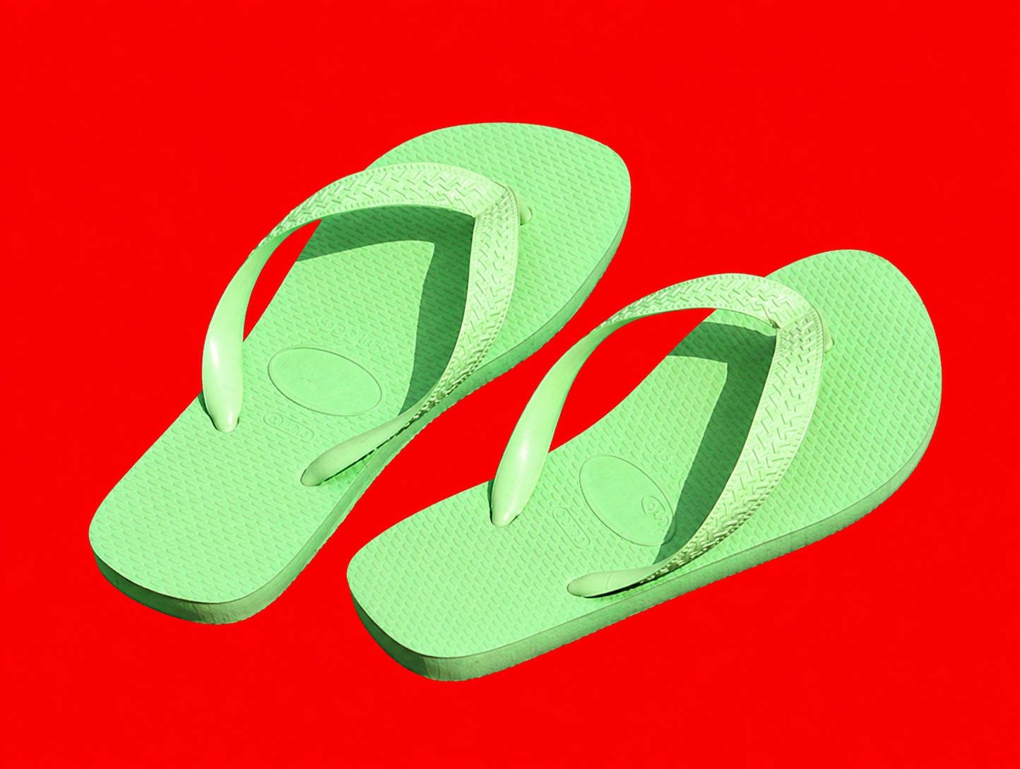 Green flip-flops on a red background